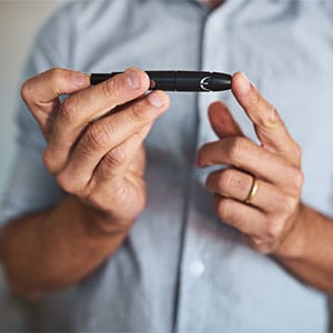 man testing his blood sugar with finger